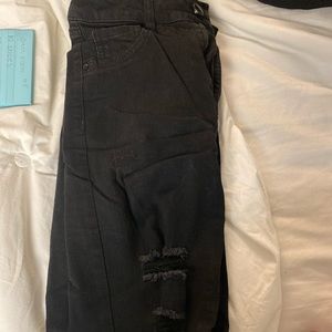 Distressed black skinny jeans